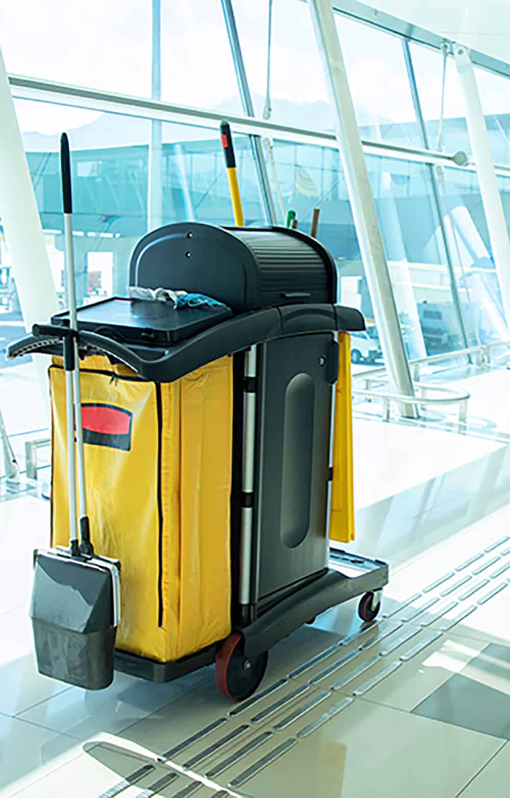 yellow cleaning cart by window